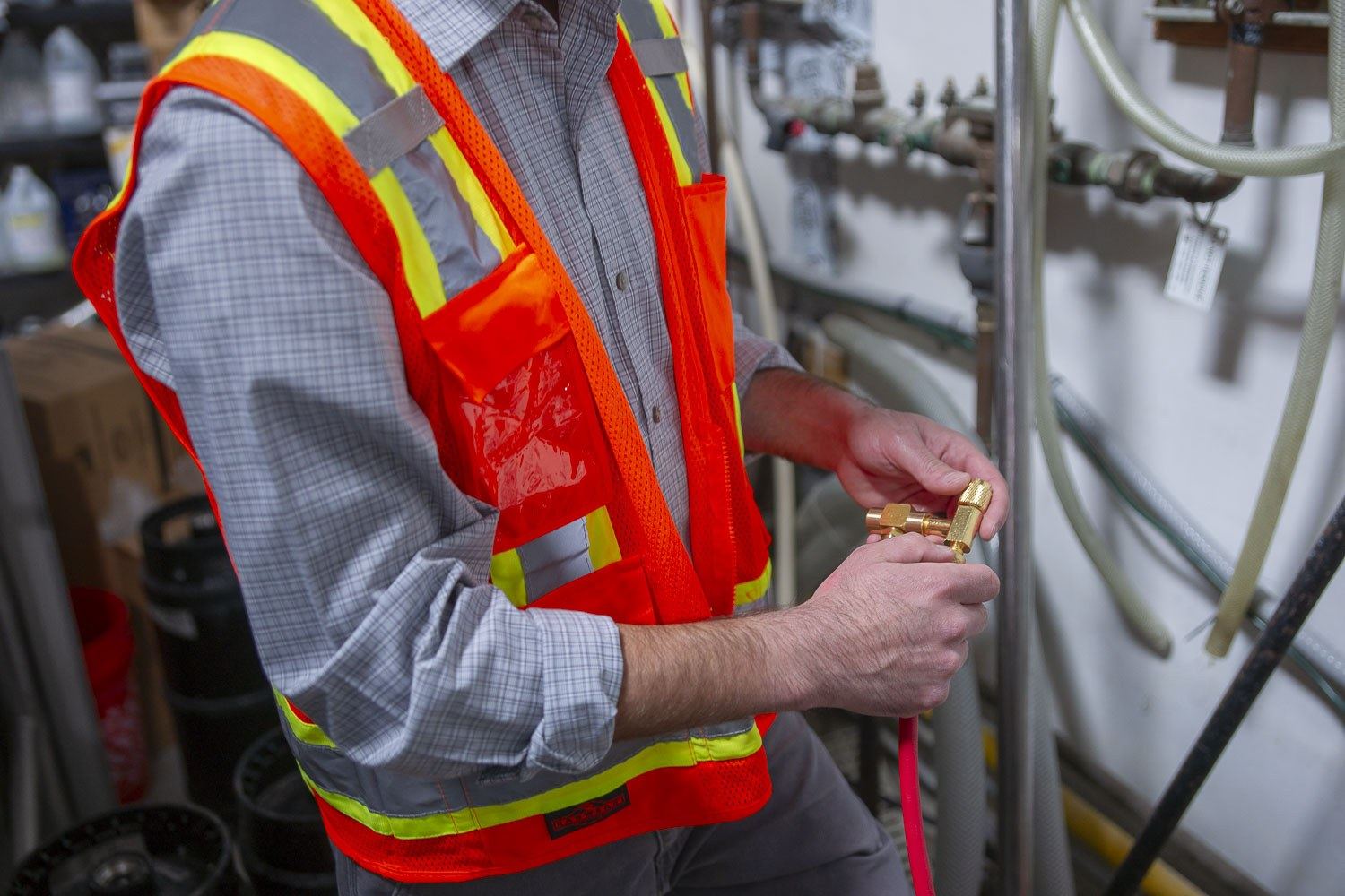 Technician replacing a fitting on a backflow assembly