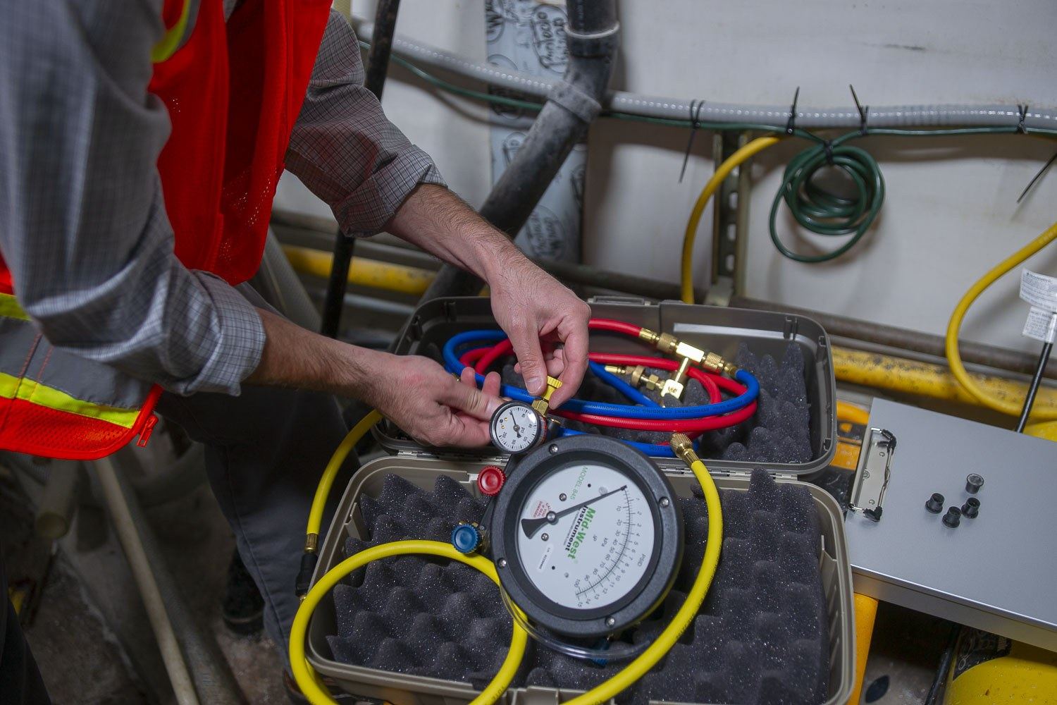 Calibrated backflow test kit gauge connected to an assembly